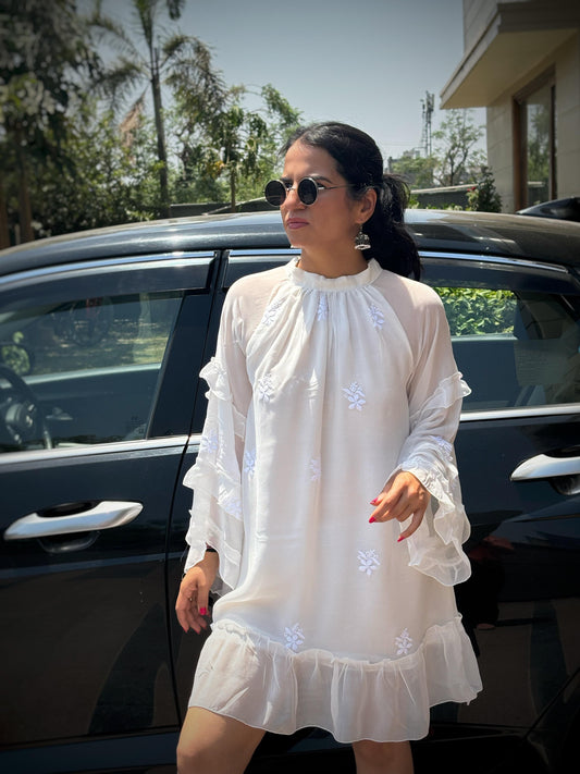 Adaa off-white Chikankari ruffle mini dress — lifestyle standing in front of car, personal occasion wear